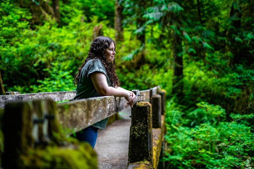 Nikki, one half of N&A Photography, on a forest bridge